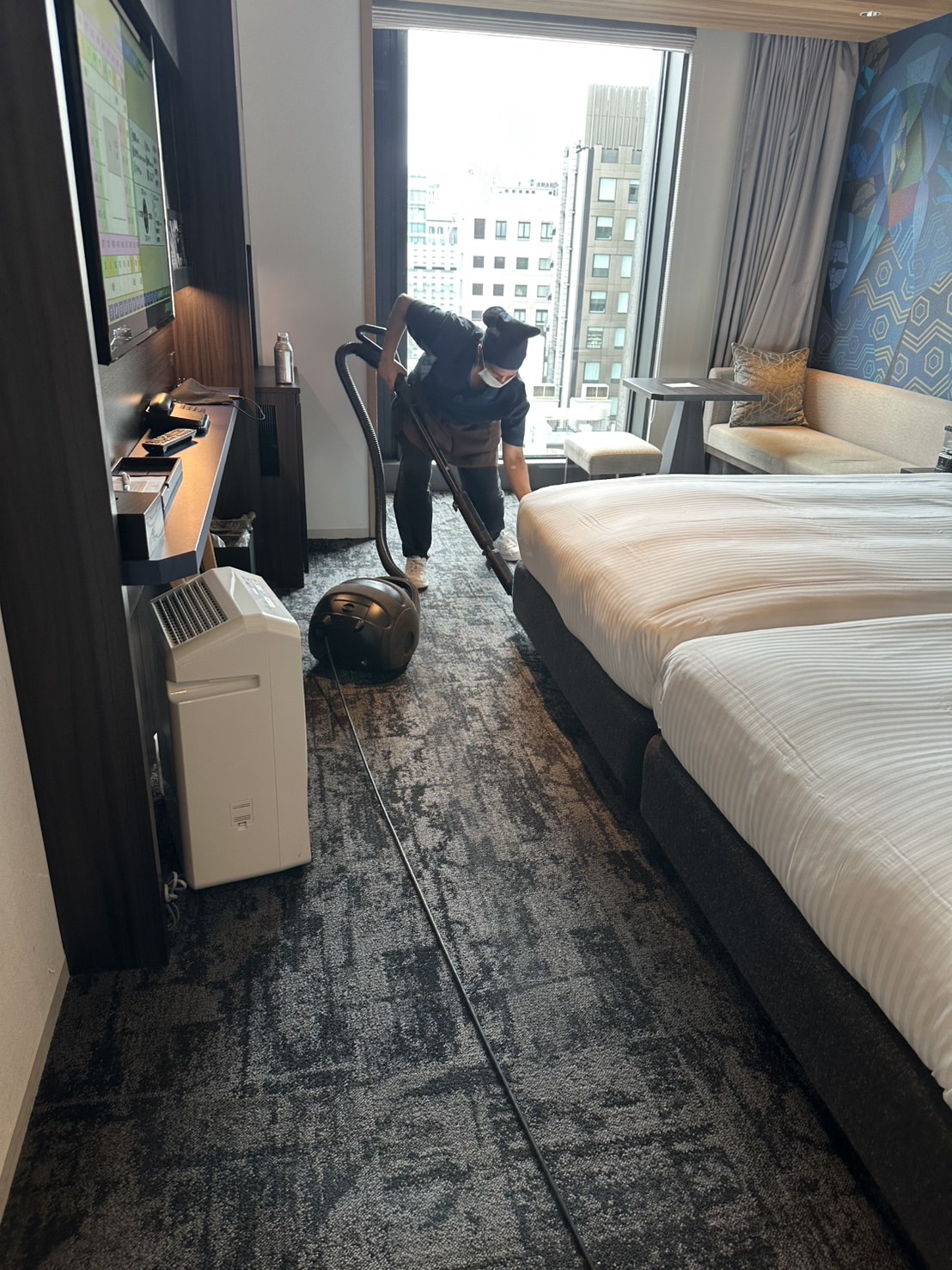 TOYAS staff cleaning a hotel guest room